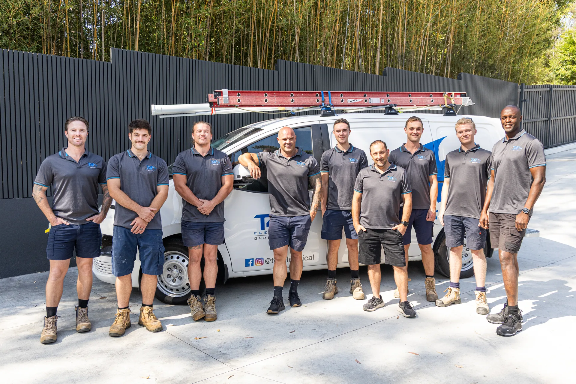 The Family Electrician Labrador team with a service van